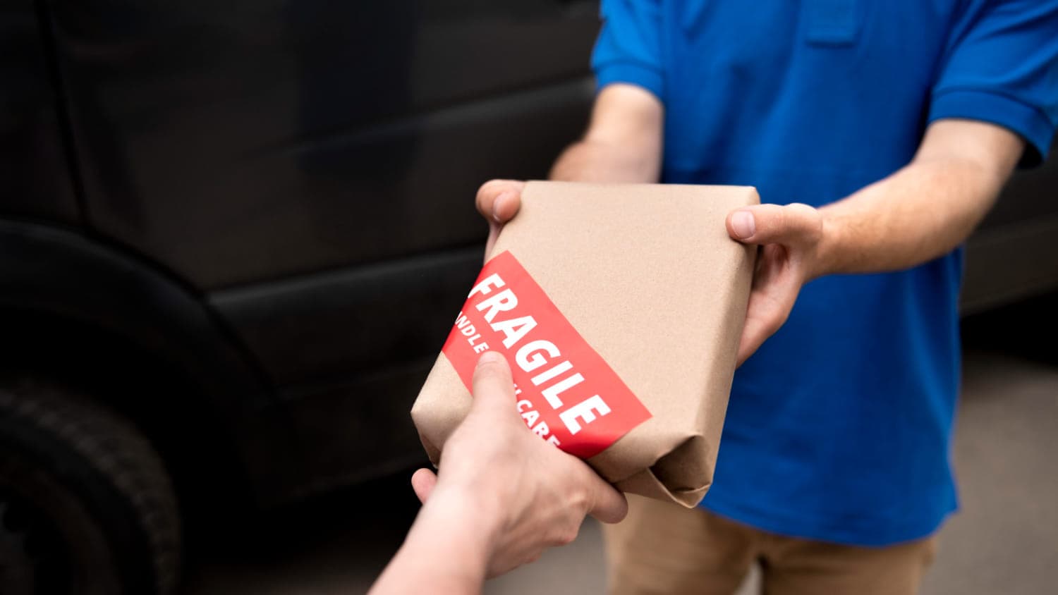 a person handing a package to another person